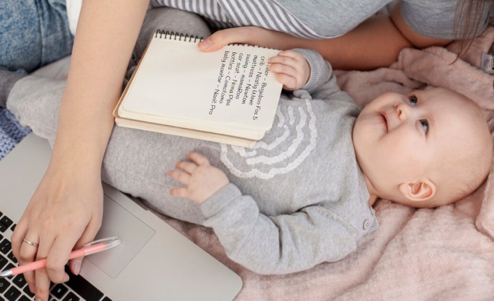 parents comparing baby products on laptop surrounded by baby gear items