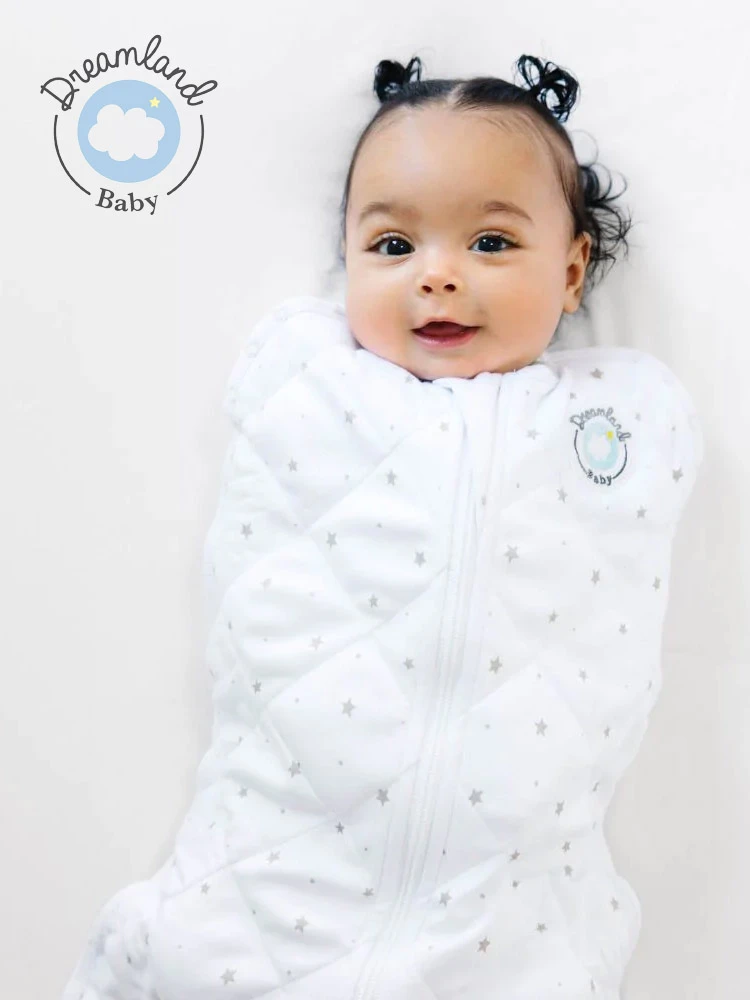 a baby sleeping in a Dreamland weighted swaddle