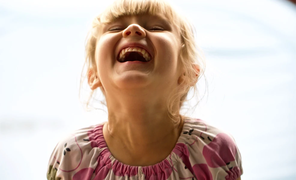 girl laughing at kids jokes