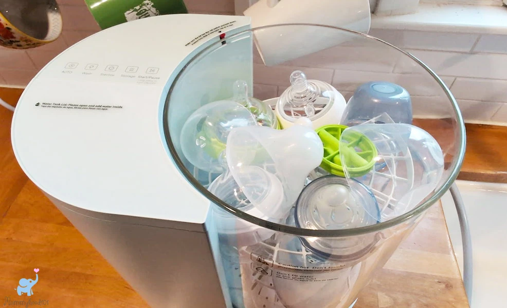 baby bottles and nipples packed into the lower rack of the grownsy bottle washer