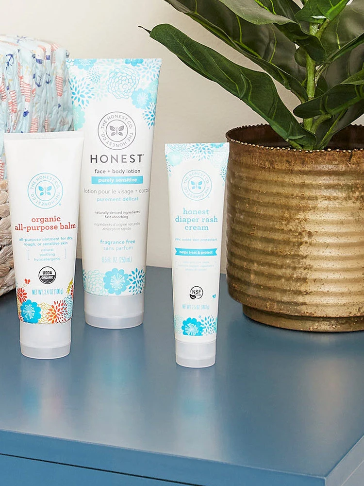 tube of honest company diaper rash cream on a nursery dresser