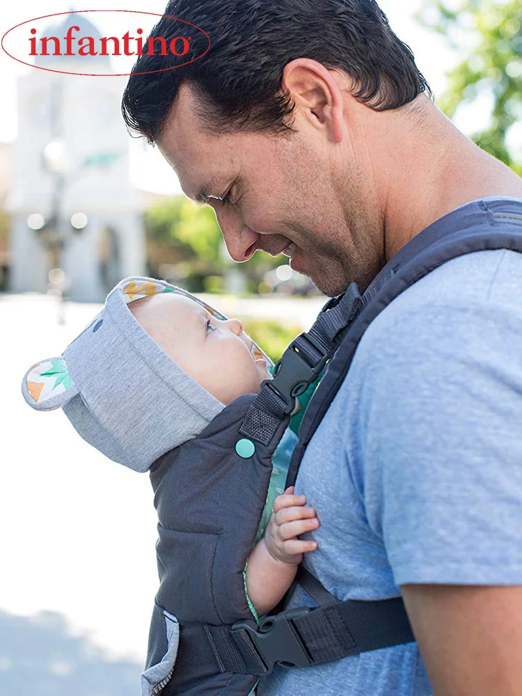 a father wearing the Infantino Cuddle Up hoodie baby carrier with bear hood