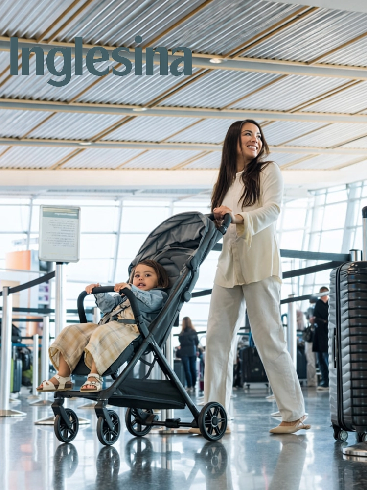 a mom pushing the inglesina quid 3 stroller through the airport with a toddler in the seat