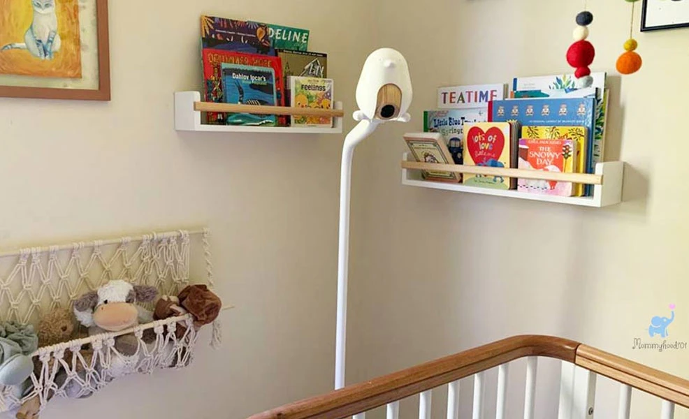 the cubo ai baby monitor in a nursery looking into a crib