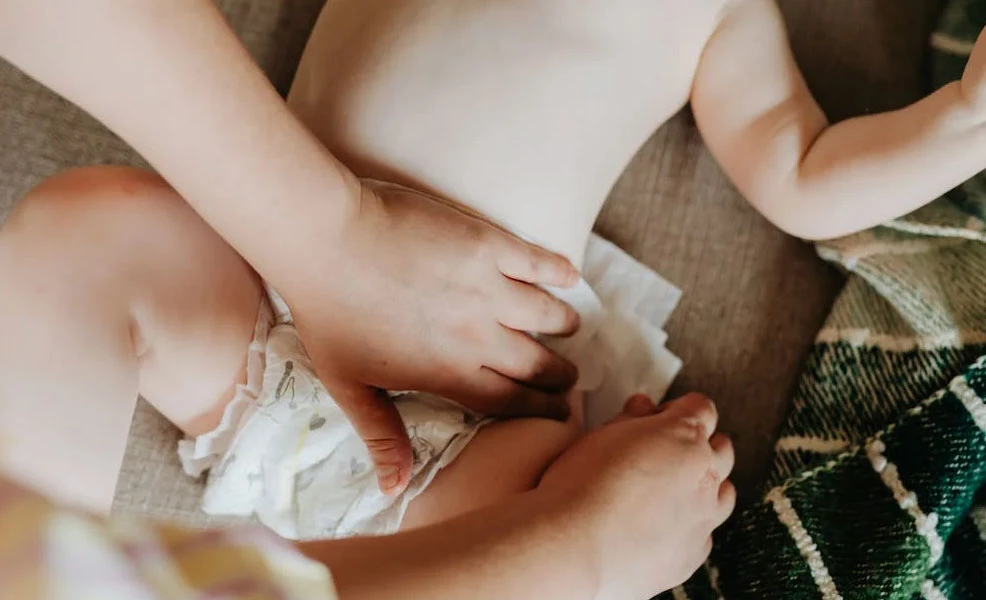 a baby laying down and getting a diaper change