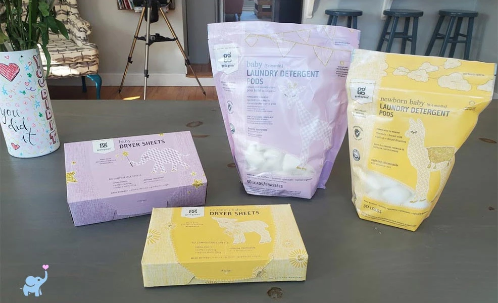 grab green baby laundry detergent pods and dryer sheets on a table