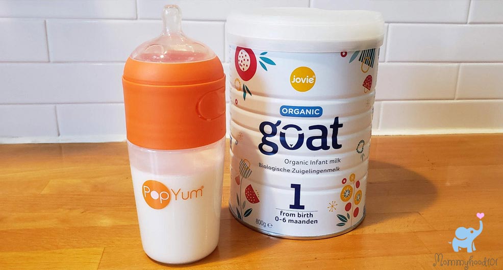 a prepared bottle of jovie baby formula alongside the tin of formula