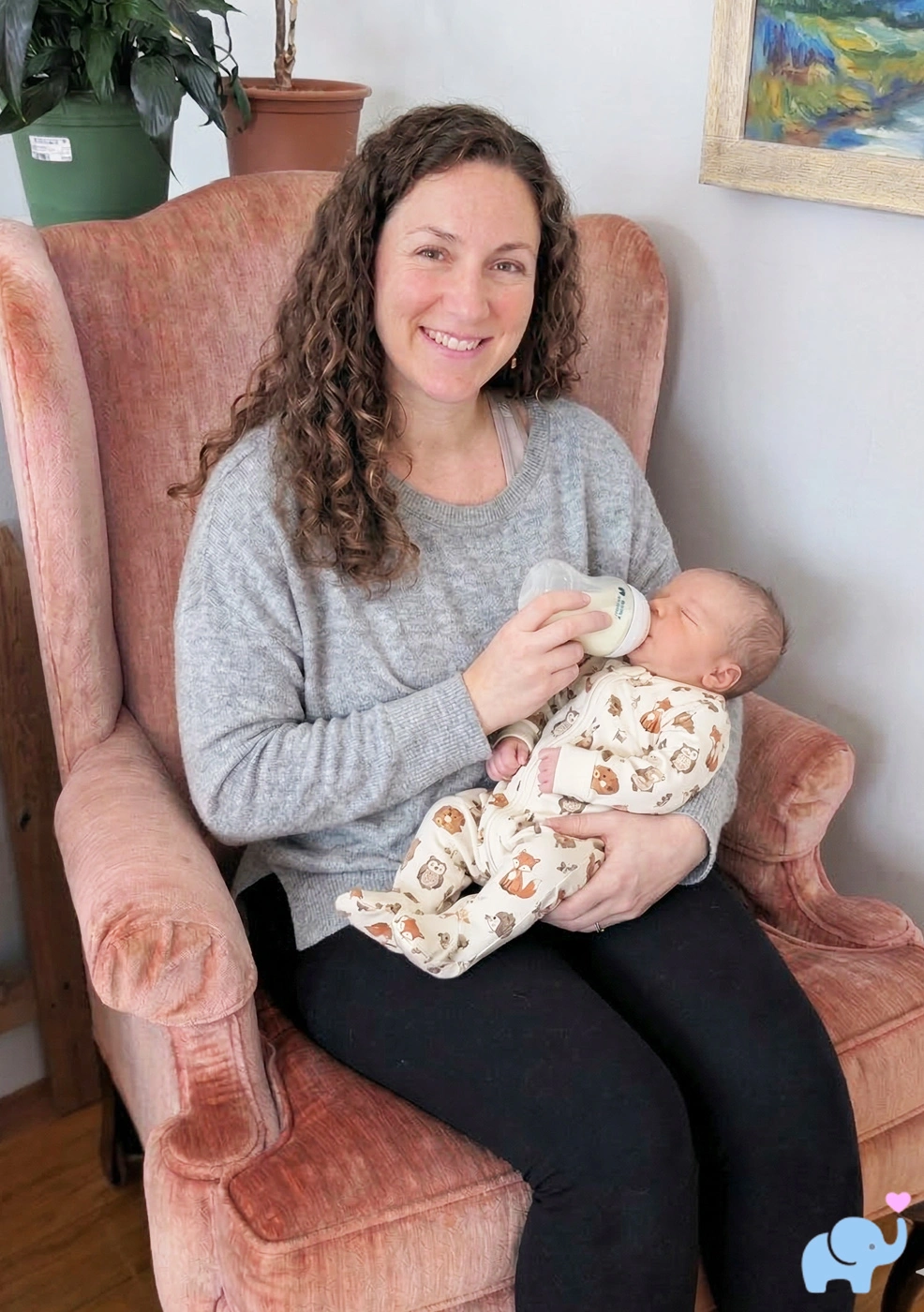 a woman sitting in a chair feeding a baby from a bottle filled with Little Spoon Organic Infant Formula
