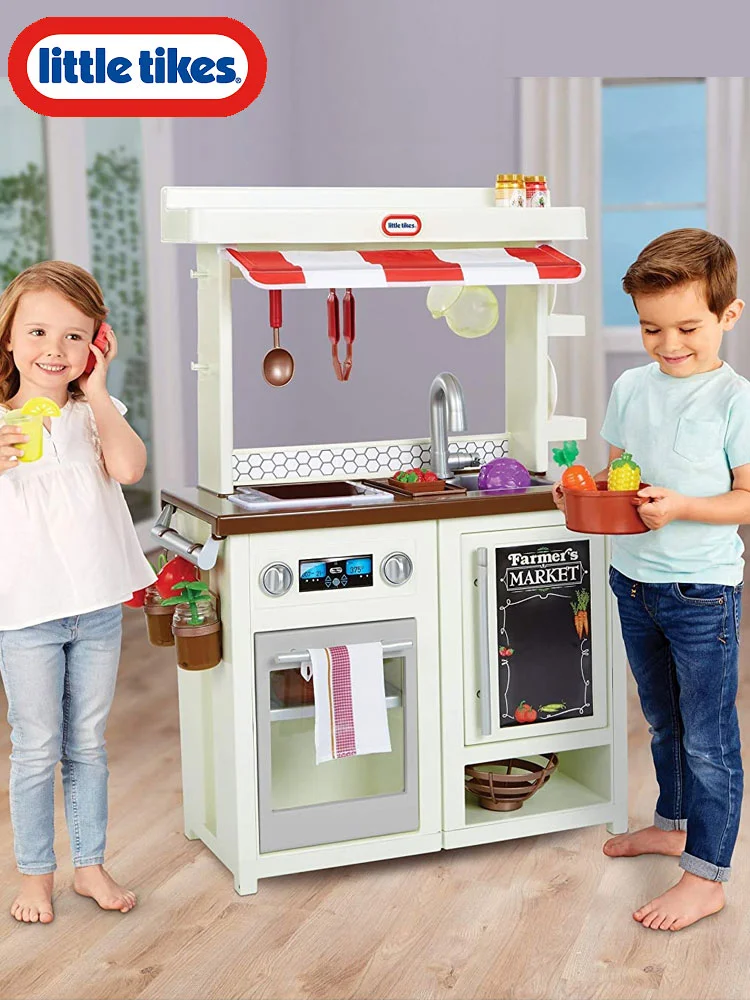 a girl and boy playing together with the little tikes farmers market play kitchen