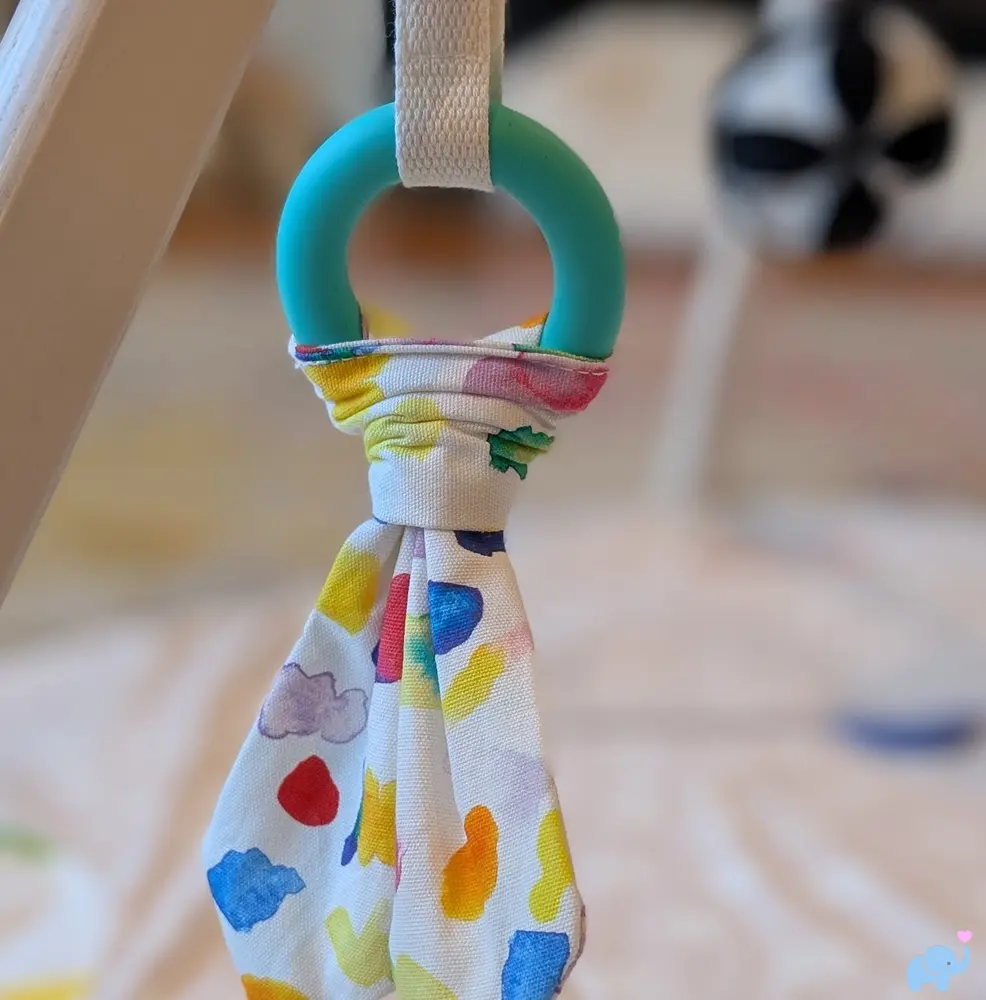 Crunchy hanging fabric toy on the Lovevery Play Gym