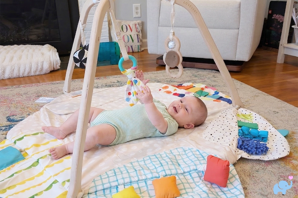 lovevery play gym review with baby playing in the playgym