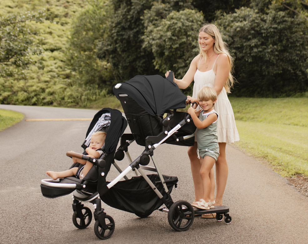 mockingbird 2.0 stroller with kids in seats on road
