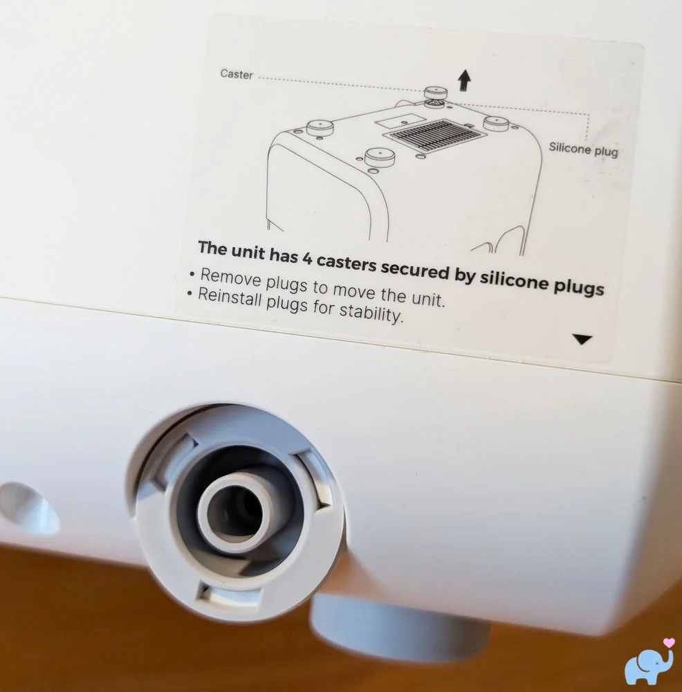 Close up of the drain port on the back of the Momcozy DeepClean Baby Bottle Washer D8