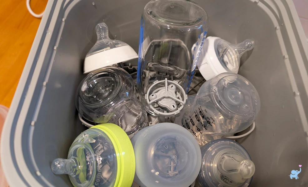 clean baby bottles in the momcozy kleanpal bottle washer pro