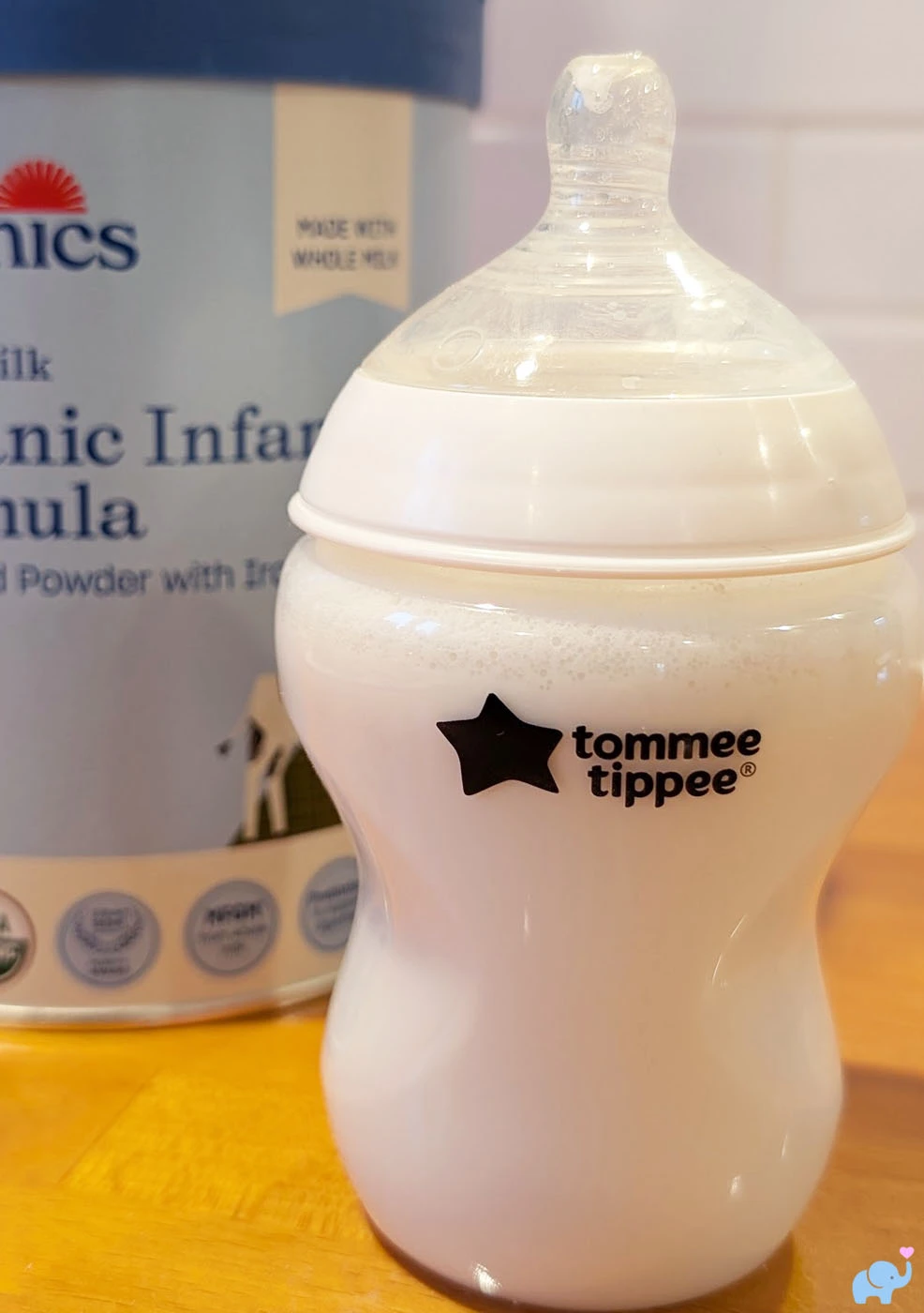 baby bottle prepared with Nara Organics formula sitting on a kitchen counter
