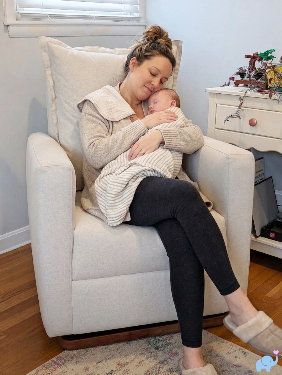 Mom rocking baby in Nestig Dawn glider