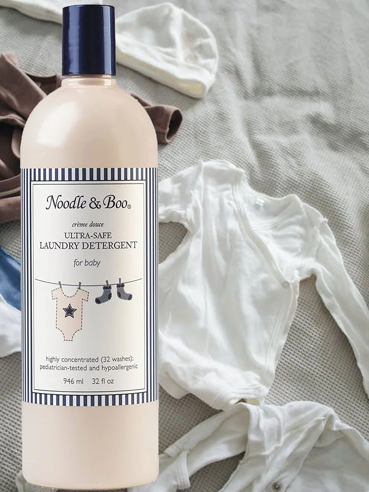 Noodle and Boo Ultra-Safe Baby Laundry Detergent bottle near baby clothes