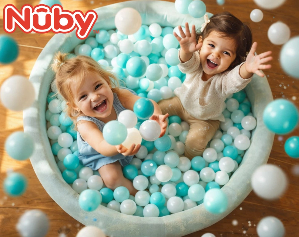 two toddlers playing in the nuby ball pit with aqua and white balls