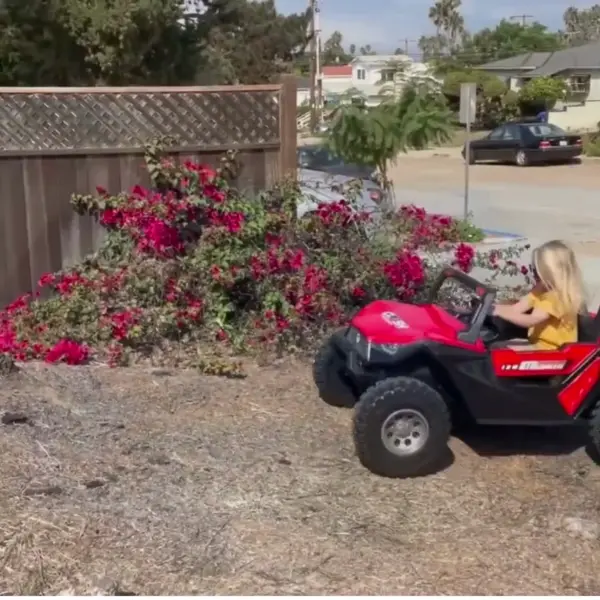 Ride-on electric car or tractor for toddlers on lawn