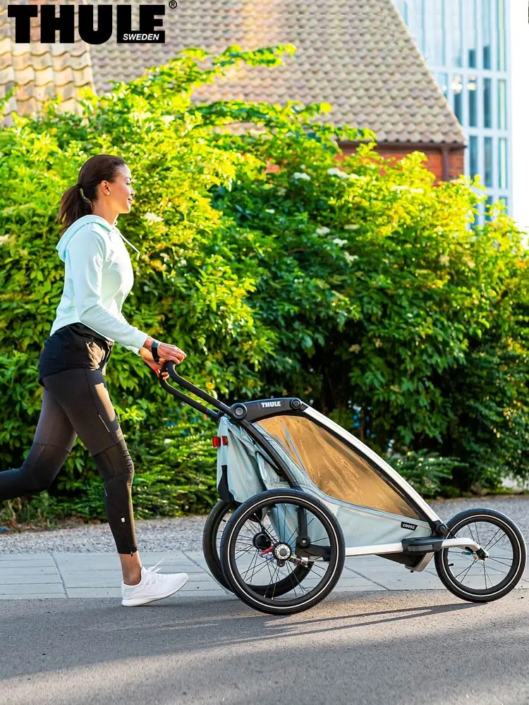 mom jogging while pushing the Thule Chariot Cross multisport stroller