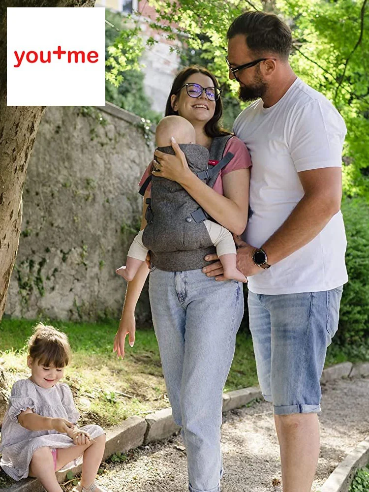 parents carrying babies in You+ME ergonomic baby carrier